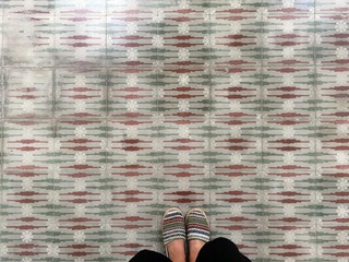 Feet over vintage tiled floor
