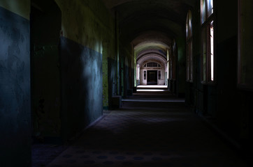 Dark corridor of the abandoned tuberculosis hospital in Germany  - obrazy, fototapety, plakaty