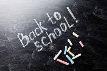Back to school background on blackboard with chalks.