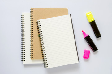 Office workplace concept. Notebook, and marker color pen on white desk.