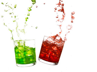 Glasses of olourful cold drinks with water splash and ice cubes.
