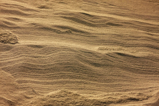 Sand shaped by the wind blowing in the waves