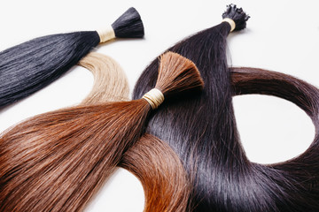 hair extensions of three colors on a white background. copyspace selective focus - 165330066