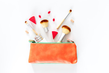 Beauty bag with cosmetics, contraceptives and pills on white table background top view copyspace