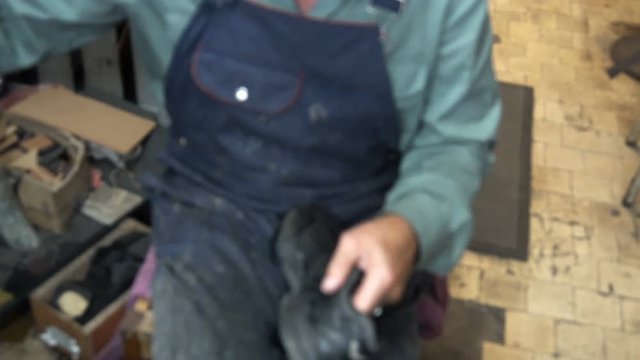 the shoemaker at work.The process of repairing shoes in workshop.