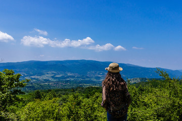 Beautiful young girl with hat enjoy the panoramic view