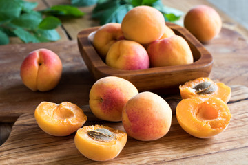 Naklejka na ściany i meble Freshly harvested apricots on a wooden table