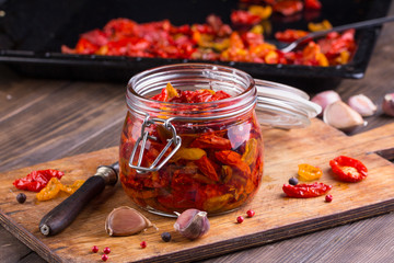 Sun dried tomatoes with olive oil in a jar - obrazy, fototapety, plakaty