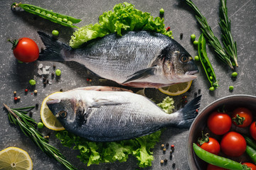 Top view of tasty dorado fish with vegetables and spices