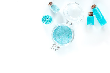 Spa set with sea salt, blue clay and lotion on white background top view copyspace