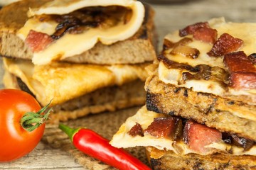 Roasted bread with egg omelet and chili pepper on a wooden table. Fastfood.