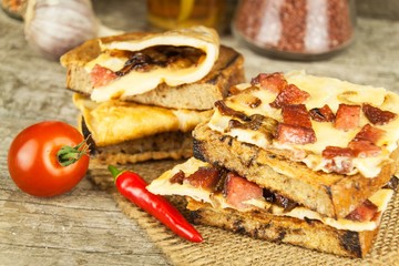 Roasted bread with egg omelet and chili pepper on a wooden table. Fastfood.