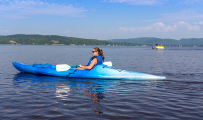 woman kayaking on a calm lake