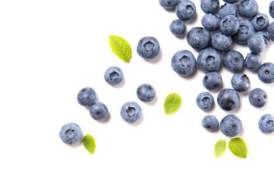 Fresh blueberries and leaves, berry frame isolated on white background, top view