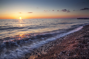 Colorful sunset with waves on the sea