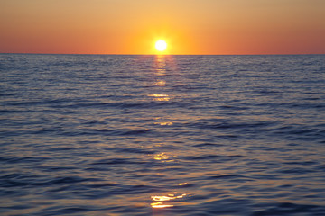 Beautiful orange sunset with blue roaring sea