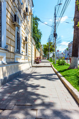 View of the city sidewalk on a summer day
