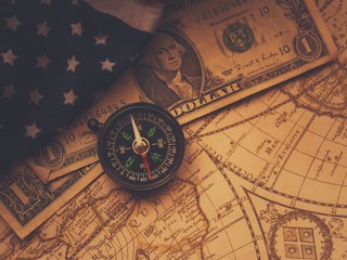 Antique pirate world map and new modern compass concept travel around the world with one dollar...