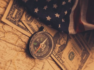 Fototapeta na wymiar Antique pirate world map and new modern compass concept travel around the world with one dollar money of United States of America, vintage vintage