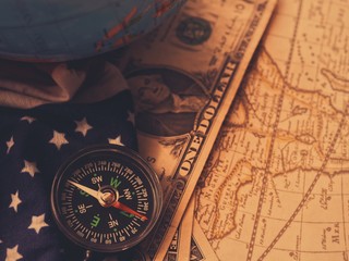Antique pirate world map and new modern compass concept travel around the world with one dollar...