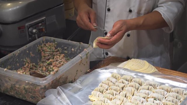 Chef Assembling Dumplings in a Singapore Restaurant
