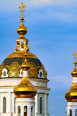 Fototapeta na wymiar The Golden domes of the Russian Orthodox Church close-up. The Church of saints Peter and Fevronia. Donetsk.