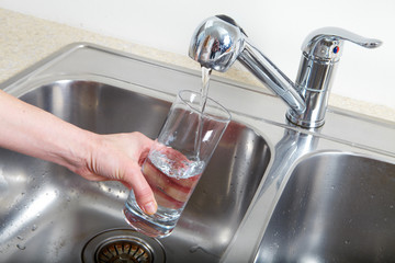 Filling glass of water