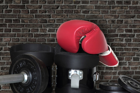 Sports equipment lies in the gym on a brick wall background