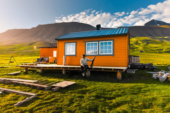 Wallpaper Norway Landscape Nature Of The Mountains Of Spitsbergen Longyearbyen Svalbard Building  On A Polar Day With Arctic Summer In The Sunset And Blue Sky With Clouds Hunter With A Gun