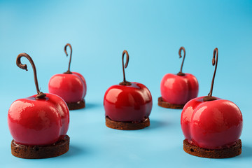 Glossy mousse cakes in the form of cherries