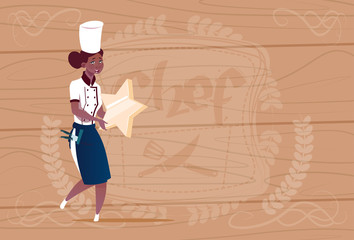 Female African American Cook Holding Star Best Chef Award Happy Cartoon Chief In Restaurant Uniform Over Wooden Textured Background Flat Vector Illustration