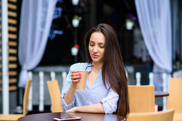 Beautiful girl smiling and drinking coffee.