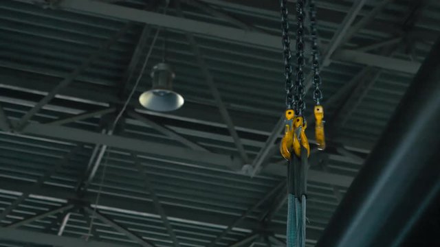 Pipe is lowered on the crane. Enterprise for production of pipes