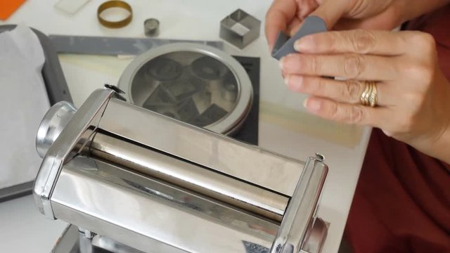 female artiest prepares soft polymer clay for her next arts and crafts project in her studio