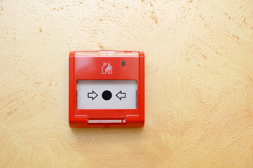 Fire alarm button installed on the wall in the room