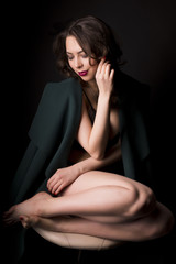 Fototapeta premium Young seductive woman in lace lingerie and warm coat