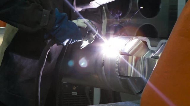 ARGON WELDING. A blacksmith or welder, with his welder, welding steel and iron