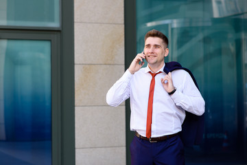 Businessman talking on the phone and smiling.