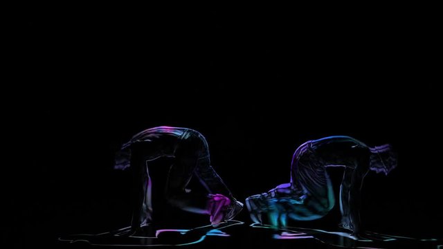Computer graphics, silhouette two mans perform brakedance on black background