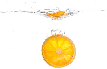 Fototapeta na wymiar orange slice in water splash on white background