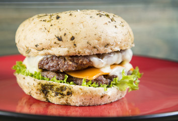 Fresh tasty hamburger on red plate