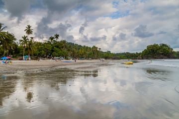 MANUEL ANTONIO, COSTA RICA - MAY 13, 2016: People on a beach in Manuel Antonio village, Costa Rica