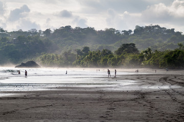 MANUEL ANTONIO, COSTA RICA - MAY 13, 2016: People on a beach in Manuel Antonio village, Costa Rica
