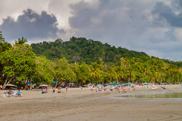 MANUEL ANTONIO, COSTA RICA - MAY 13, 2016: People on a beach in Manuel Antonio village, Costa Rica
