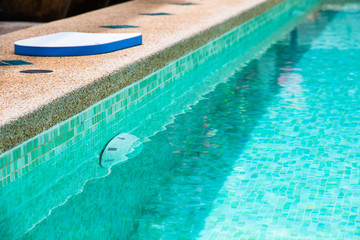 Fototapeta na wymiar Modern backyard of a swimming pool with clear water
