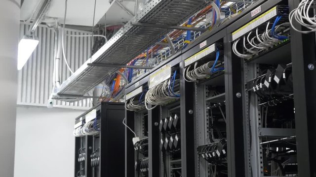 Row of bitcoin miners set up on the wired shelfs. Computer for Bitcoin mining. cables plug to motherboard for mining machine. Cryptocurrency computer with many peripheral slots