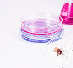 pills analyzing. pills and color liquid in petri dishes. laboratory, science and clinic background.