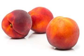 Fototapeta na wymiar Three uncut, whole, ripe peaches fruit