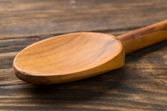 Wooden cooking spoon on wood board or table