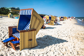 Wicker chairs on Jurata beach on sunny summer day, Hel peninsula, Baltic Sea, Poland - obrazy, fototapety, plakaty